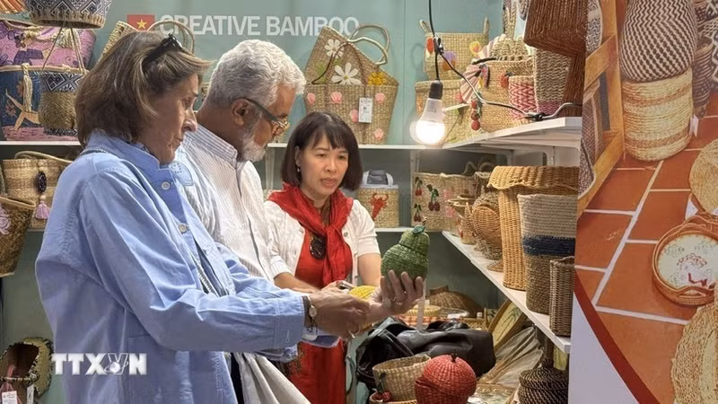 Des étrangers découvrent des produits vietnamiens. Photo : VNA.