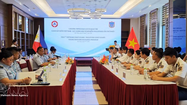 De jeunes officiers des garde-côtes vietnamiens et philippins échangent leurs expériences en matière de police maritime. Photo : VNA. 