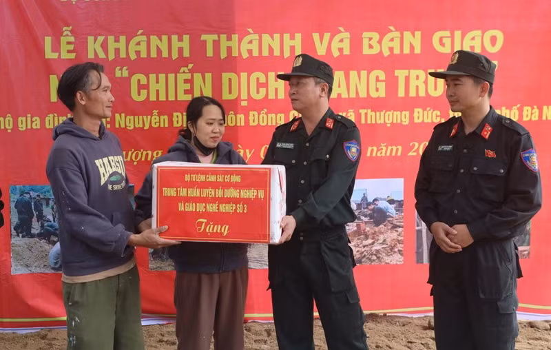 Le général de division Pham Hong Phuc (à droite), du commandement de la police mobile, félicite la famille de Nguyen Dinh, commune de Thuong Duc, pour leur nouvelle maison. Photo : VNA.
