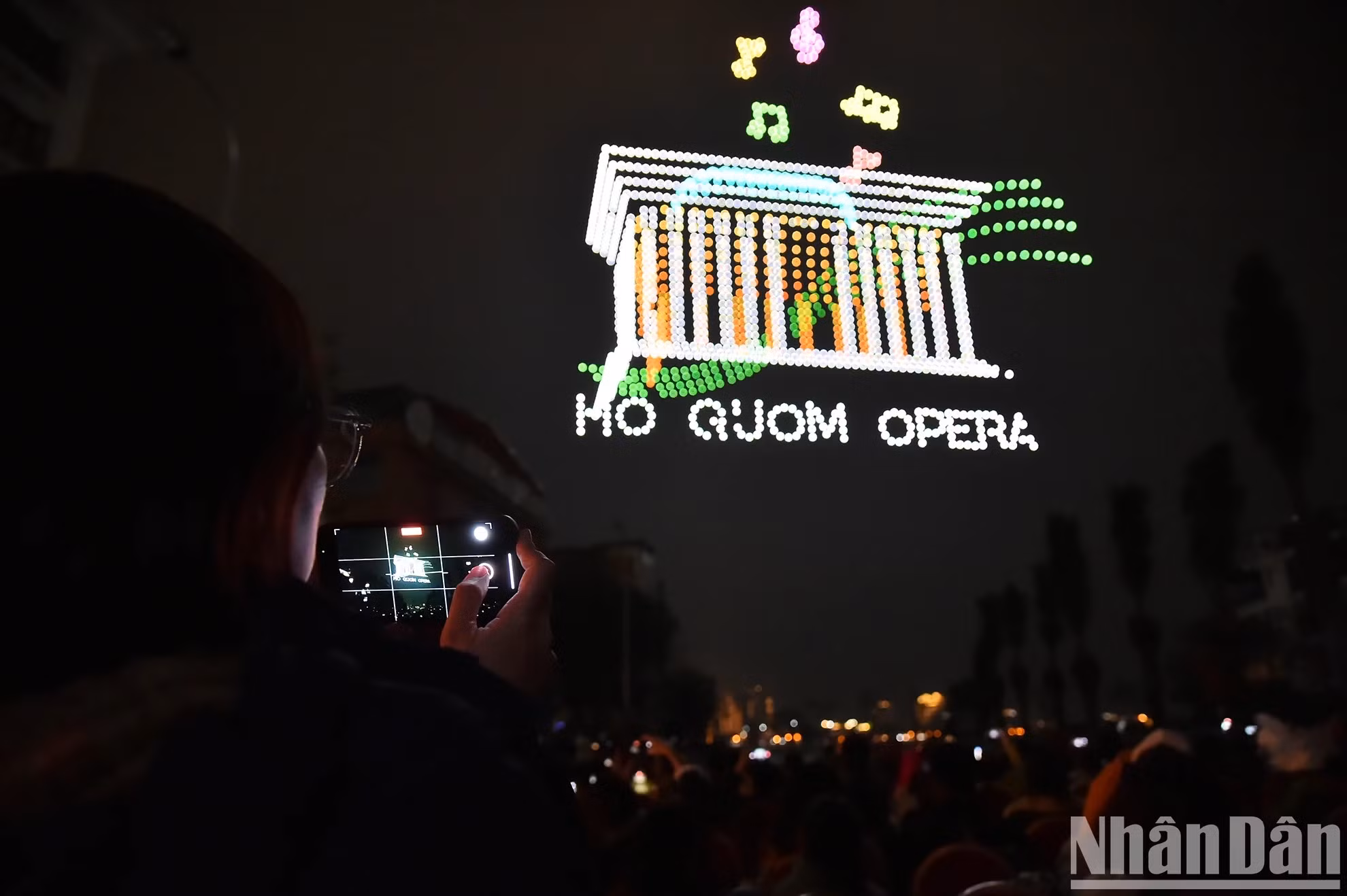 Les résidents et les touristes capturent avec enthousiasme les moments de ce spectacle de lumière artistique impressionnant.