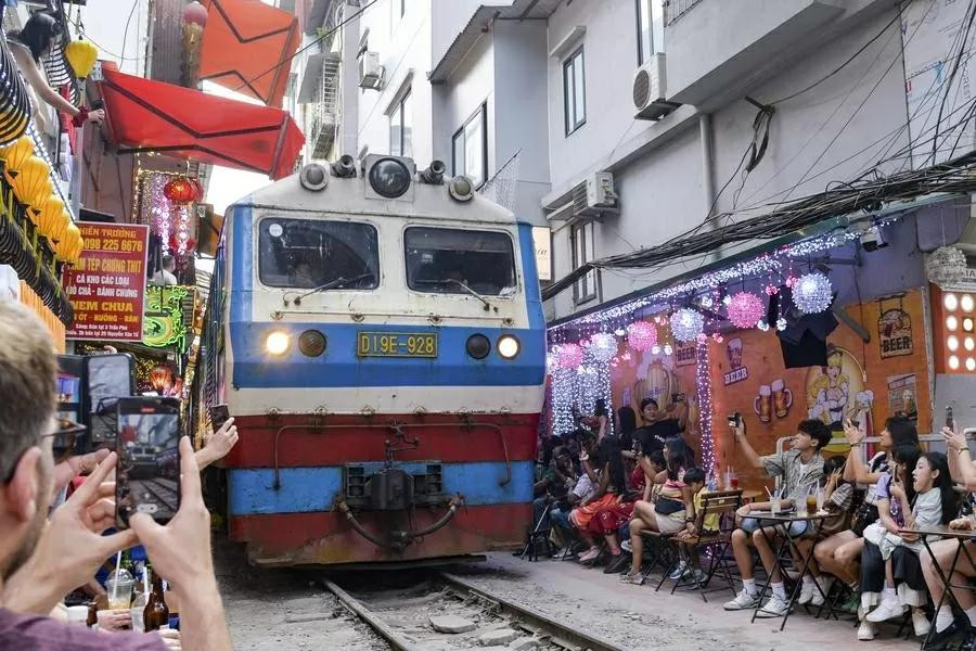 De nombreux touristes affluent dans la célèbre rue du train pour capturer des images du passage des trains. Photo : Xinhua. De nombreux touristes affluent dans la célèbre rue du train pour capturer des images du passage des trains. Photo : Xinhua.