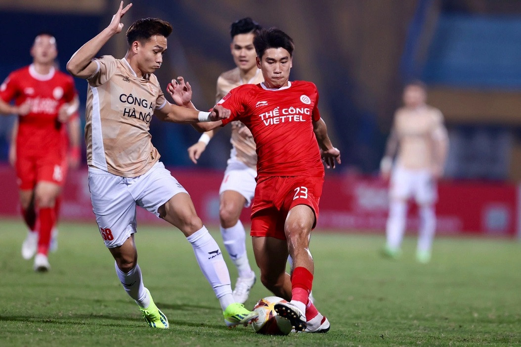 Des joueurs de The Cong et de Police de Hanoi se battent pour un ballon lors d'un match. Photo : Dantri. Des joueurs de The Cong et de Police de Hanoi se battent pour un ballon lors d'un match. Photo : Dantri.