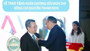 L’ambassadeur Rogelio Polanco Fuentes remet l’Ordre de l’amitié de l’État cubain à Nguyên Thanh Nghi, membre du Comité central du Parti communiste du Vietnam et chef de la Commission centrale des politiques et de stratégies du Parti. Photo : VNA. 