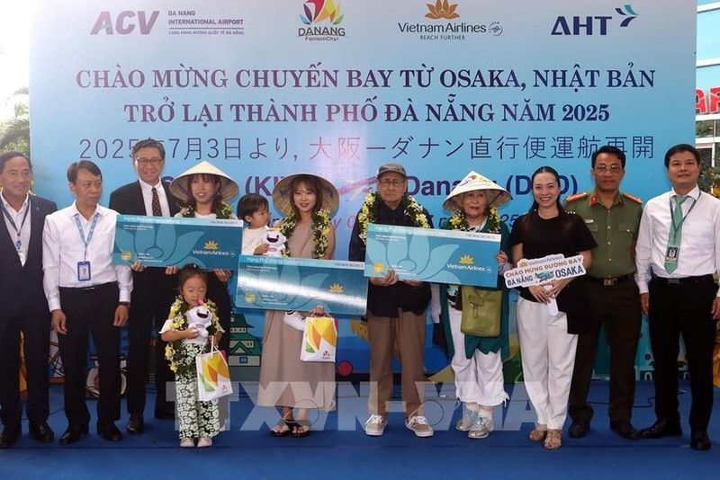 Lors de la cérémonie d'accueil, le comité d'organisation a offert des fleurs et des cadeaux à trois heureux invités du vol VN337 Osaka-Da Nang. Photo : VNA.