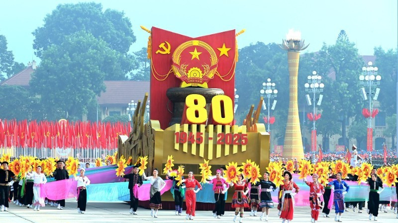 Un véhicule miniature portant l'emblème national de la République socialiste du Vietnam mène le défilé militaire et le cortège de masse. Photo : VNA.