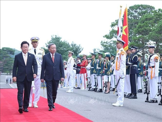 Le président sud-coréen Lee Jae Myung et le secrétaire général du Parti Tô Lâm (droite) passent en revue la garde d’honneur. Photo: VNA