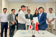 Les représentants de l’Association pour la promotion de la coopération économique Vietnam–Japon (VJECPA, à gauche) et de l’Union financière des zones industrielles du Vietnam échangent le protocole d’accord de coopération. Photo : VOV