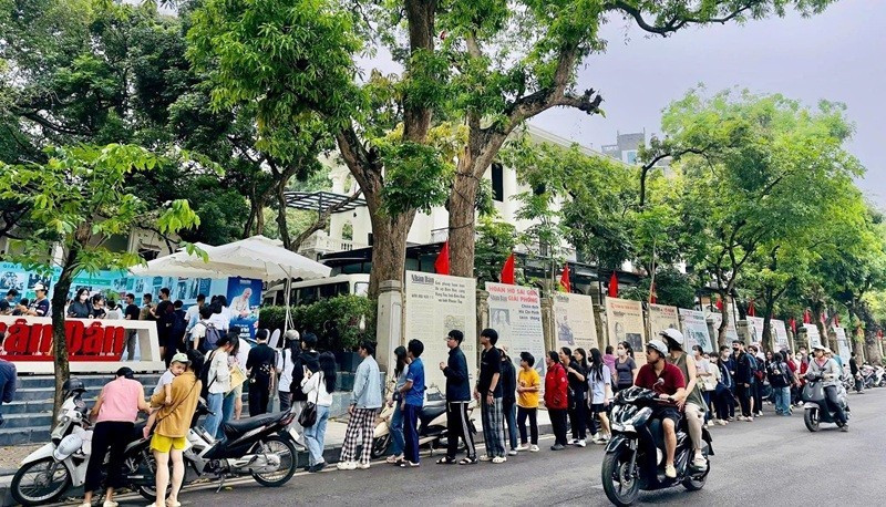 Dans le cadre de la campagne de communication marquant le 135e anniversaire de la naissance du Président Ho Chi Minh, de nombreux lecteurs de la génération Z ont fait la queue pour recevoir le numéro spécial du Journal Nhân Dân. Photo : nhandan.vn 