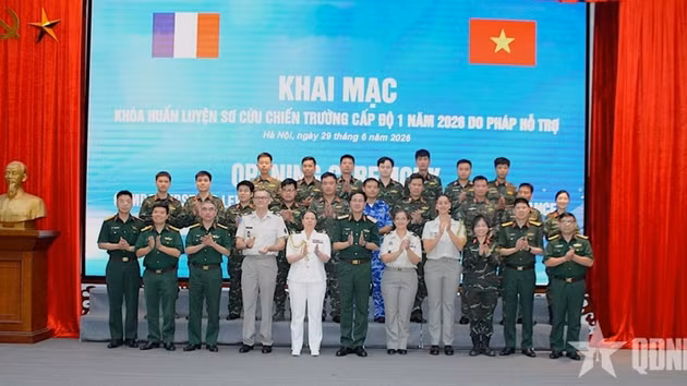 Le général de brigade Pham Manh Thang, chef du Département du maintien de la paix du Vietnam et la colonelle Anne Brun entourés des formatrices et des stagiaires. Photo : QĐND.