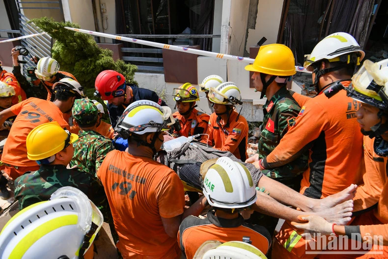 Les forces de secours de l'Armée populaire vietnamienne, en coopération avec celles du Myanmar, ont sauvé une personne après plus de 100 heures d'enfouissement. Photo : nhandan.vn