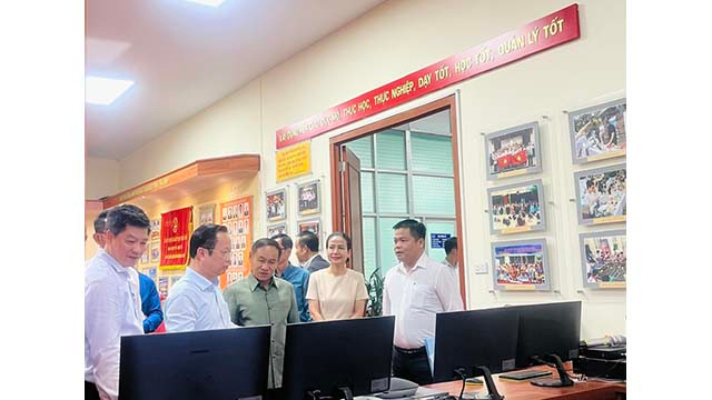 Le directeur du Département de l'éducation et de la formation de Hanoï, Trân Thê Cuong, présente le Centre opérationnel intelligent du Service de l'éducation et de la formation de Hanoi à la délégation du Service de l'éducation et des sports de la province de Champassak. Photo : kinhtedothi.vn