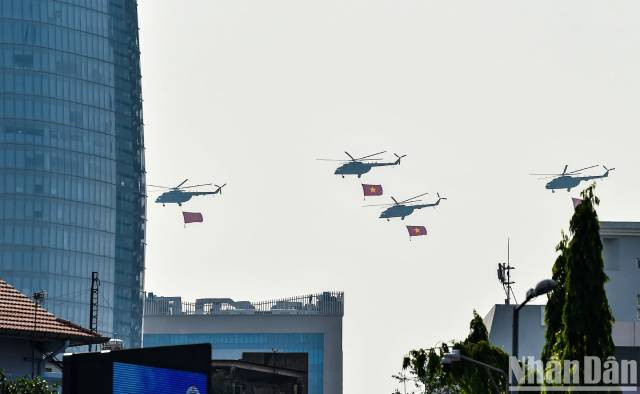 Les hélicoptères Mi-8 et Mi-17, arborant le drapeau du Parti et le drapeau national, se dirigent vers l’estrade officielle. Photo : nhandan.vn Les hélicoptères Mi-8 et Mi-17, arborant le drapeau du Parti et le drapeau national, se dirigent vers l’estrade officielle. Photo : nhandan.vn