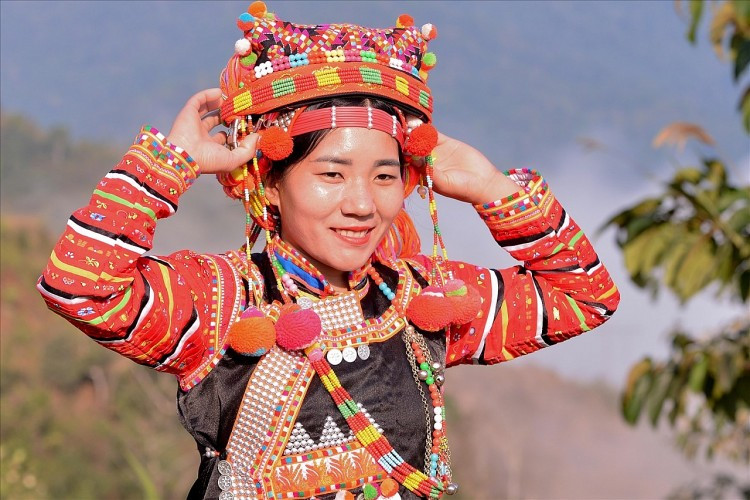 Le portrait d’une femme de l’ethnie Hà Nhì resplendit dans les tons rouge orangé. Photo : baodantoc.vn
