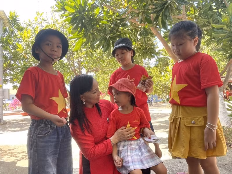 Nguyen Thi Dung, une Vietnamienne vivant en République tchèque, avec des enfants à Truong Sa. Photo: thoidai. Nguyen Thi Dung, une Vietnamienne vivant en République tchèque, avec des enfants à Truong Sa. Photo: thoidai.