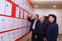 Des électeurs consultent la liste des candidats dans la circonscription n° 13. Photo : VNA.