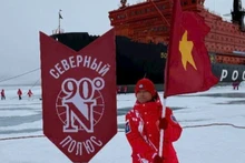 Un jeune explorateur hisse le drapeau rouge à étoile d’or au pôle Nord