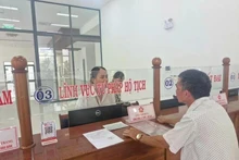 Un homme dépose ses demandes le jour de l'expérimentation du modèle d'administration locale à deux niveaux, dans le quartier de Pleiku, à Gia Lai. Photo : VNA.