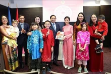 Le Premier ministre vietnamien Pham Minh Chinh et son épouse offrent des livres d'apprentissage du vietnamien à la communauté des Vietnamiens en Estonie. Photo : VNA.