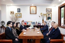 Le secrétaire général Tô Lâm converse avec des membres de la famille du Premier ministre Pham Van Dông. Photo : VNA.