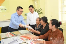  Le rédacteur en chef Le Quoc Minh a offert aux habitants locaux le supplément spécial publiant les projets de documents soumis au XIVe Congrès national du Parti.