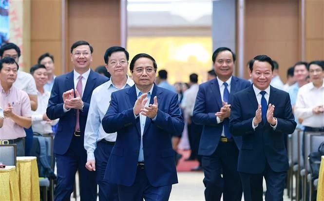 Le Premier ministre Pham Minh Chinh a présidé une conférence nationale en ligne le 22 juin afin d'examiner les programmes nationaux ciblés pour la construction de Nouvelle ruralité et la réduction durable de la pauvreté. Photo : VNA. 