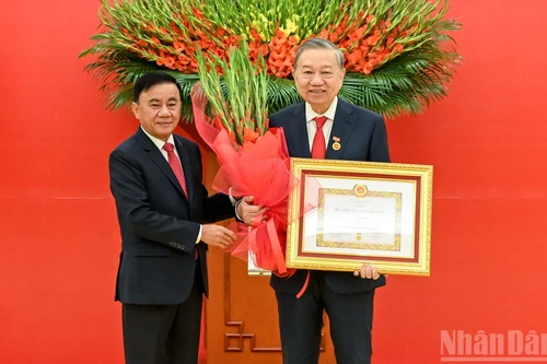 Le permanent du Secrétariat, Tran Cam Tu, remet l’insigne des 45 ans d’adhésion au Parti au secrétaire général Tô Lâm. Photo : NDEL.