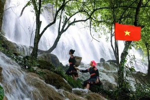 Des jeune filles Thaï posent avec grâce au bord de la cascade Reu. Photo: nhandan.vn 