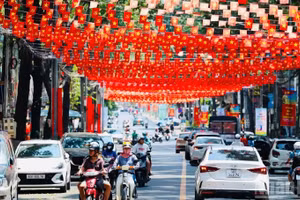 Le drapeau rouge à étoile jaune est hissé dans de nombreux quartiers résidentiels de Tran Bien. Photo: nhandan.vn
