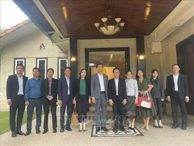 L'ambassadeur du Vietnam en Malaisie Dinh Ngoc Linh (centre) et la délégation de l'ambassade ont pris des photos avec des responsables de l'ambassade du Laos en Malaisie. Photo : VNA. 