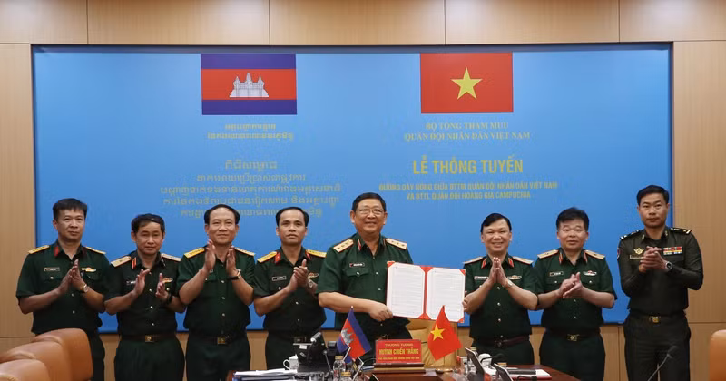 Le général de corps d'armée Huynh Chien Thang, chef adjoint de l'état-major général de l'Armée populaire du Vietnam signe un document sur l'ouverture d'une ligne téléphonique directe entre l'État-major général de l'Armée populaire du Vietnam et le commandement général des forces armées royales du Cambodge. Photo : VNA.