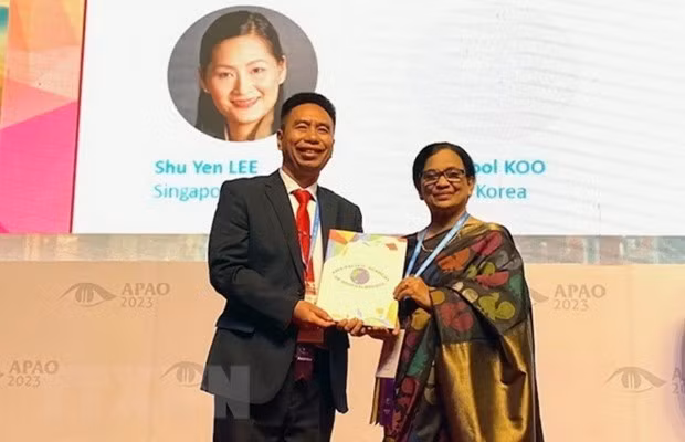 La professeure Ava Hossain, présidente de l’APAO remet le prix au médecin Nguyên Viêt Giap. Photo : VNA.