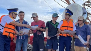 Des mesures concrètes Garde-côtes sensibilisant les pêcheurs à la lutte contre la pêche INN. Photo ; VNA/CVN.