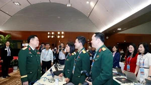 Le général d’armée Nguyen Trong Nghia visite et encourage les journalistes au Centre de presse du XIVᵉ Congrès. Photo : QĐND.