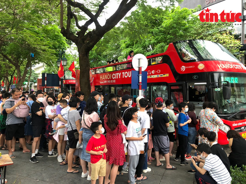 De nombreux touristes effectuent des visites gratuites dans la capitale en bus touristiques à impériale. Photo: baotintuc