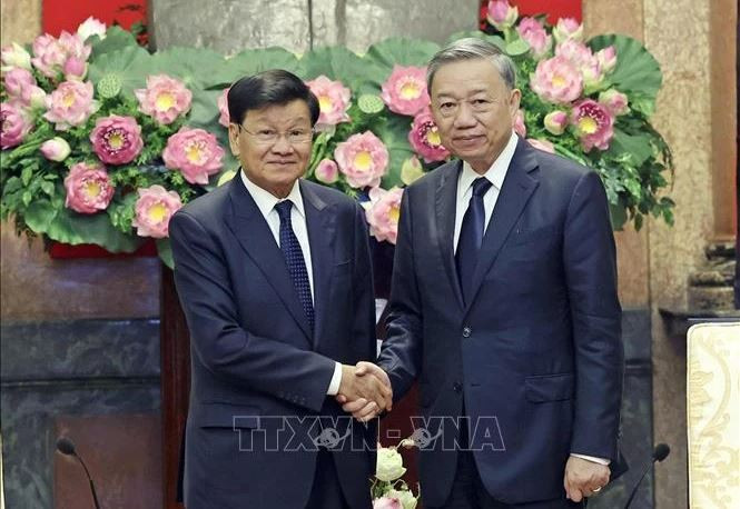 Le président To Lam (droite) et le secrétaire général du PPRL et président lao, Thongloun Sisoulith. Photo : VNA.