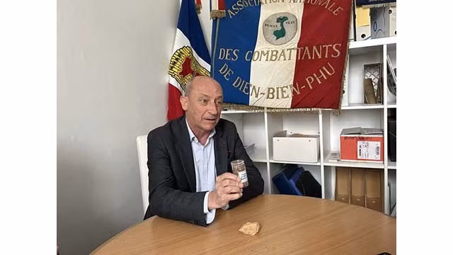 Le général Philippe de Maleissye présente le pot de terre et une pierre qu'il a rapportés de la colline A1 à Diên Biên Phu. Photo : VNA.