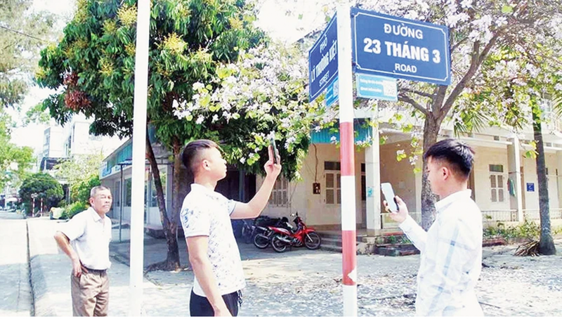 Les touristes scannent le code QR pour accéder à des informations sur le tourisme sur l'île de Cô Tô. Photo : NDEL.