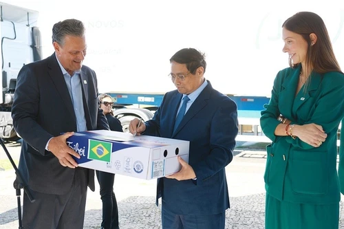 Le Premier ministre Pham Minh Chinh signe sur le premier lot de bœuf brésilien exporté vers le Vietnam. Photo : VNA.
