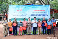 Le colonel Ha Van Nam, schef adjoint du Détachement économique et de défense 74, et des représentants des autorités du district d’Oyadav et des forces armées cambodgiennes offrent des cadeaux aux habitants cambodgiens. Photo : QDND.