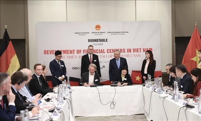 Le vice-Premier ministre permanent vietnamien Nguyên Hoa Binh (debout, deuxième à droite) et des représentants d'entreprises allemandes assistent à la signature d'un protocole d'accord entre l'Association des jeunes entrepreneurs vietnamiens en Europe et l'Association allemande des petites et moyennes entreprises. Photo : VNA.