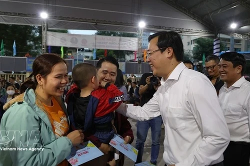 Lê Quôc Phong, secrétaire adjoint permanent du Comité du Parti de Hô Chi Minh-Ville, distribue des cadeaux aux travailleurs avant leur départ en bus pour rentrer chez eux le 12 février. Photo : VNA.
