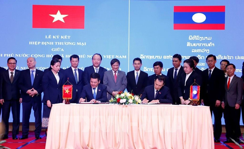 La signature du nouvel accord commercial entre le Vietnam et le Laos. Photo : VNA