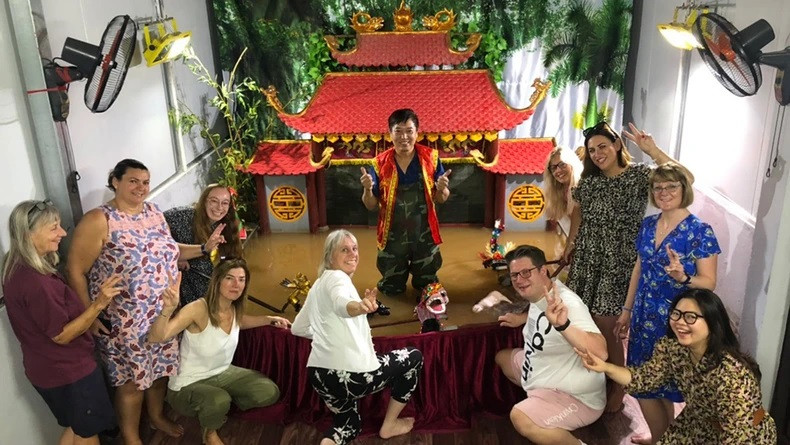 Les touristes visitent et interagissent avec l’artiste Phan Thanh Liêm dans son mini pavillon aquatique. Photo : NDEL. Les touristes visitent et interagissent avec l’artiste Phan Thanh Liêm dans son mini pavillon aquatique. Photo : NDEL.