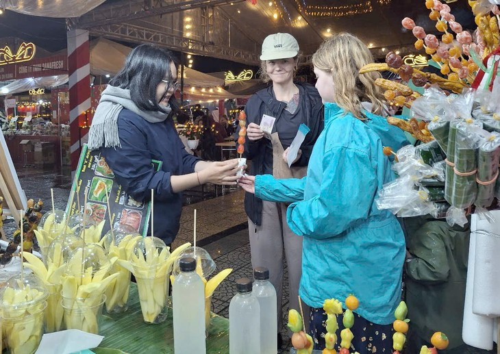 Des touristes savourent des plats vietnamiens au Festival Noël-Nouvel An 2025 de Da Nang. Photo : Dinh Thiêu/VOV.