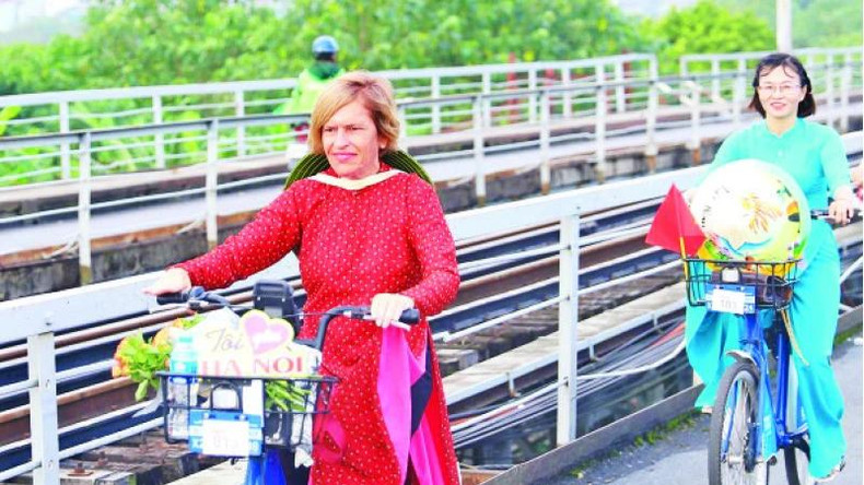 Mme Stella Ciorra lors d'un voyage à vélo pour promouvoir l'áo dài du Vietnam.