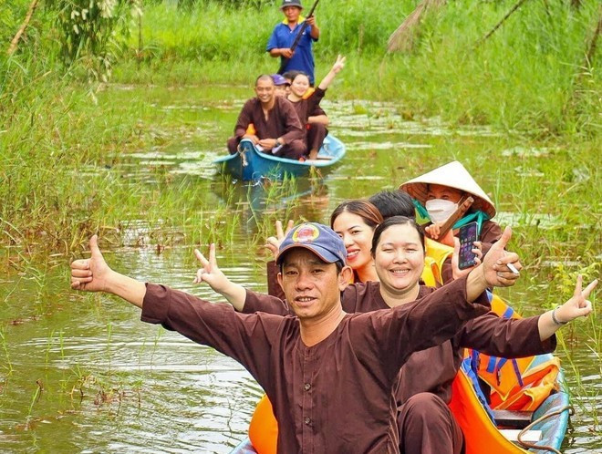 Les visiteurs apprécient les balades en pirogue à travers la forêt, au sein d’un site de tourisme écologique dans la région de la forêt d’U Minh Hạ. Photo: VNA.