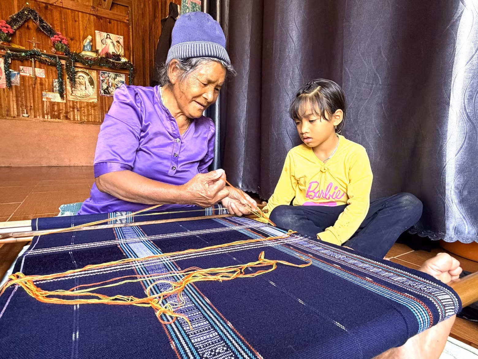 Bon Nieng Ka Lang initie sa petite-fille aux techniques traditionnelles du tissage Co Ho.