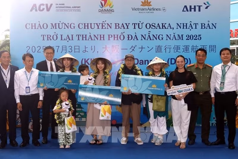 Lors de la cérémonie d'accueil, le comité d'organisation a offert des fleurs et des cadeaux à trois heureux invités du vol VN337 Osaka-Da Nang. Photo : VNA.
