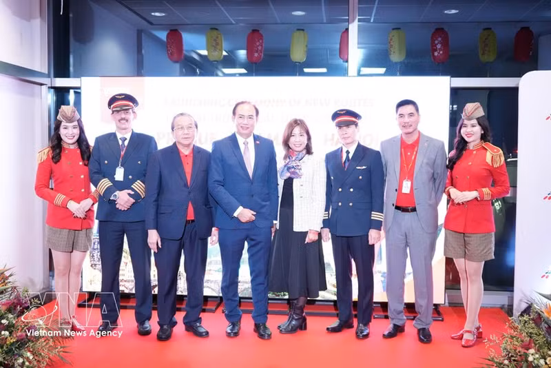 Les dirigeants et les membres d'équipage de Vietjet Air posent pour une photo avec les invités présents à la cérémonie d'ouverture. Photo : VNA 