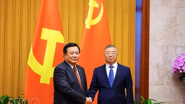 Nguyen Xuan Thang (gauche), président du Conseil théorique central et vice-président du Comité directeur chargé des travaux de bilan portant sur 100 ans de direction de la révolution vietnamienne par le Parti communiste du Vietnam (PCV) et sur 40 ans de mise en œuvre du Programme d’édification du pays pendant la période de transition vers le socialisme, et Li Shulei, membre du Bureau politique, secrétaire du Secrétariat du Comité central du Parti communiste chinois (PCC) et chef du Département de l’information du Comité central du PCC. Photo : VNA.